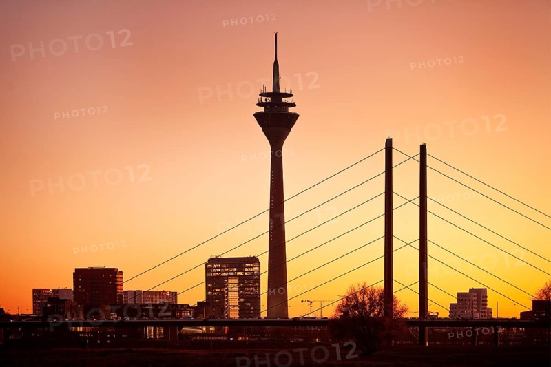 Silhouette at sunset with city gate