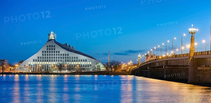Bridge over Duena River with National Library at dusk