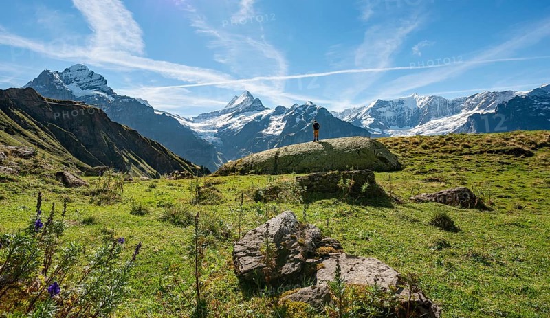 Hiker stands on a large rock