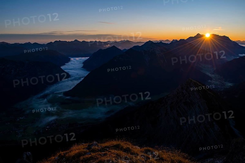 Sunrise over Lechtal Alps with fog in the valley