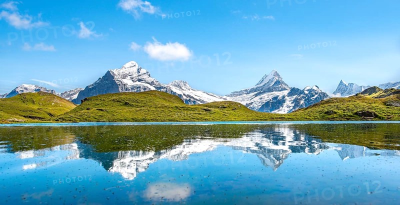 Summits Schreckhorn and Finsteraarhorn are reflected in the Bachalpsee