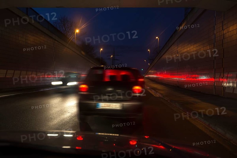 Driving cars at night in the tunnel exit