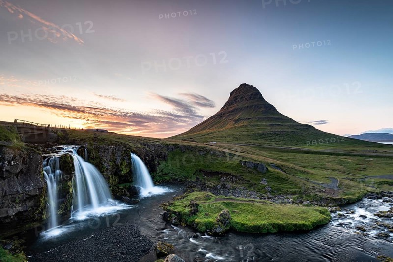 Waterfall Kirkjufellsfoss and mountain Kirkjufell at sunset