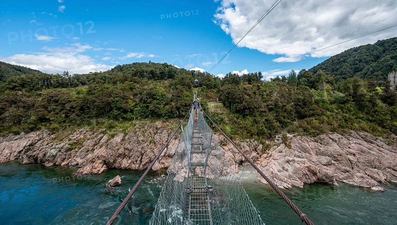 Young man on suspension bridge over Buller River