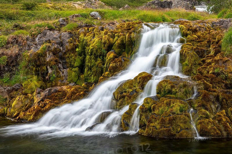 Waterfall overgrown with moss near Dynjandi