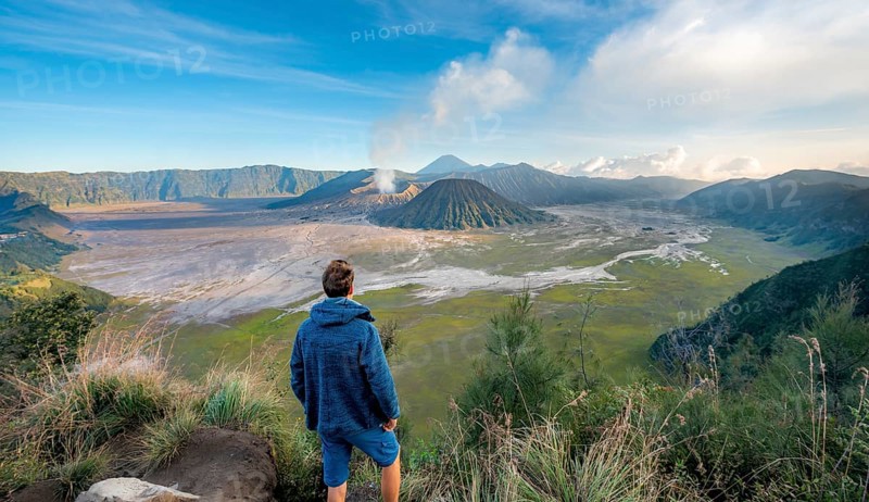 Young man in front of volcanic landscape