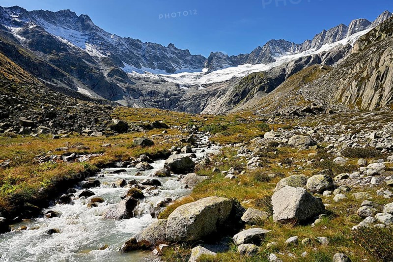 Damma glacier in front of a torrent in autumnal surroundings