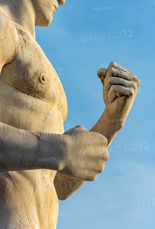 Close-up of fists of fighter statue at Stadio dei Marmi