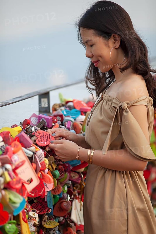 Woman looking at love locks and hearts