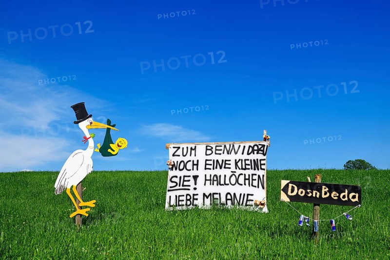 Rattling stork and banner as a welcome for a newborn child