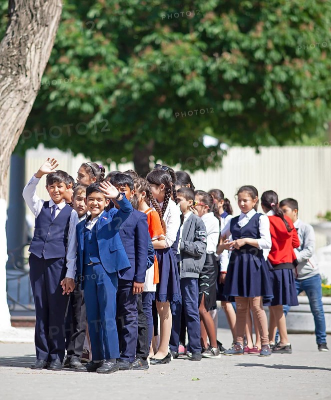 Happy students in evening dress on the university boulevard