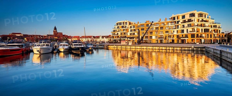 City harbour with modern hotel complex in the evening light