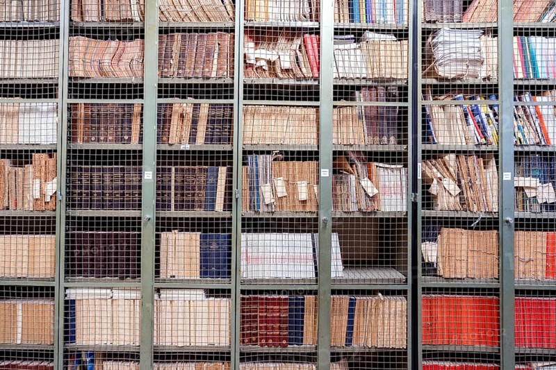 Locked bookshelves with plenty of old books