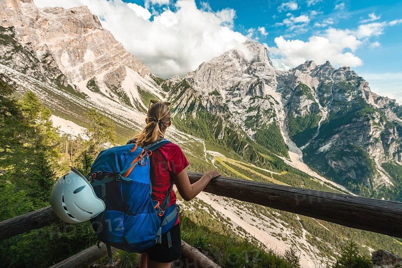 Hiker overlooks mountain landscape
