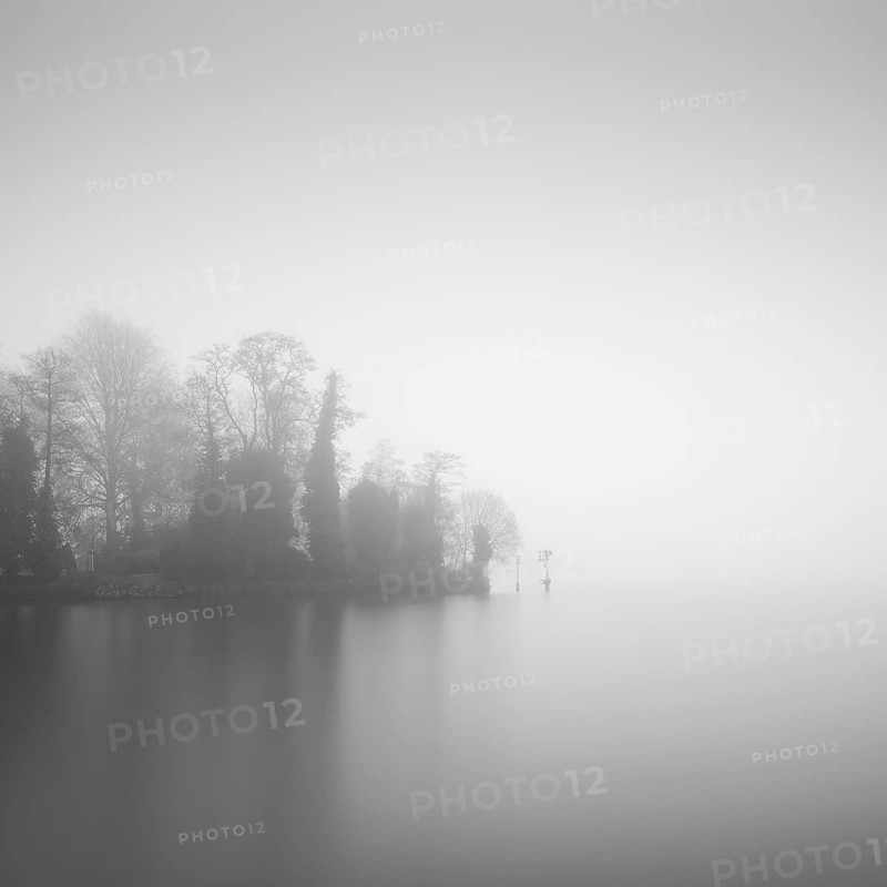 Tip of the castle island on the Dahme in Berlin Koepenick in the early morning in the thick fog