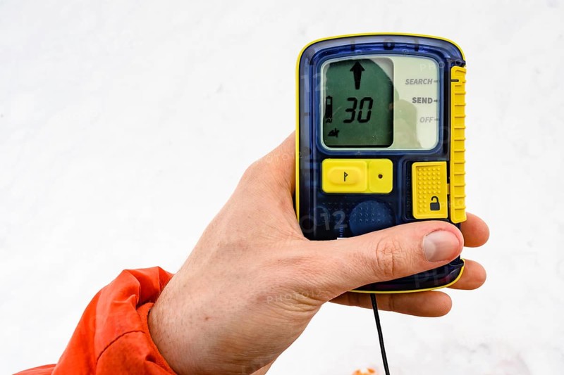 Ski tourer holds avalanche transceiver