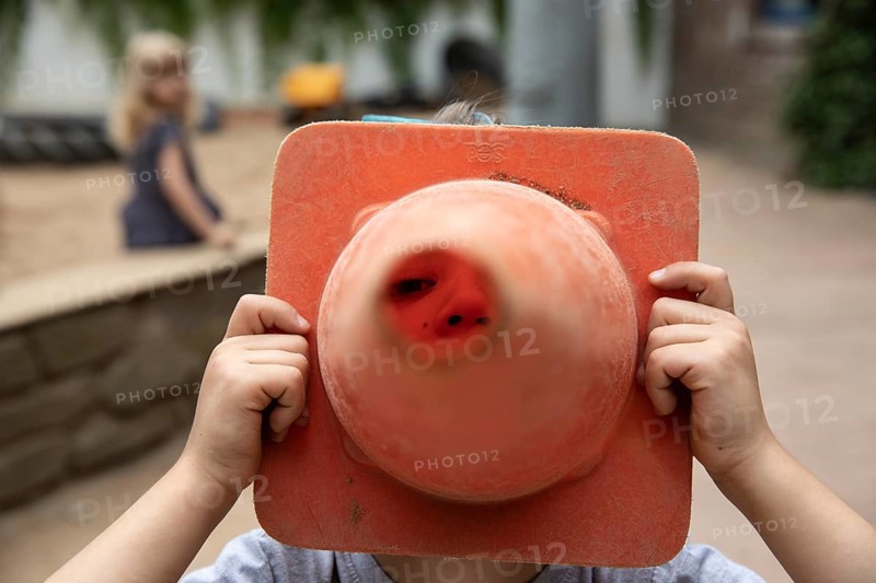 Boy plays with wobble cone