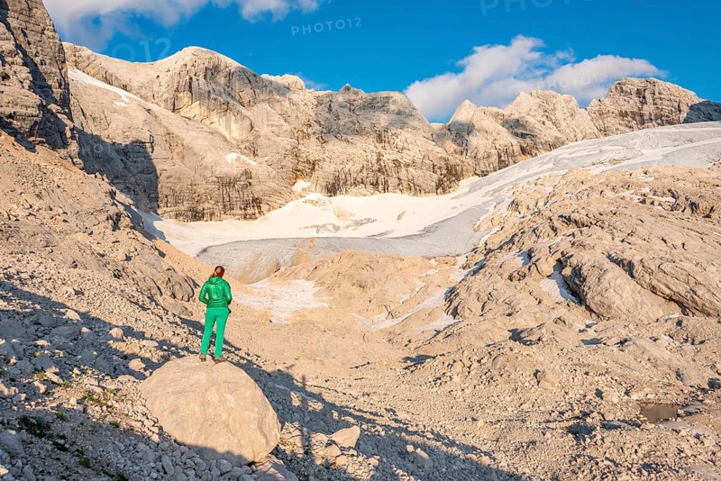 Hiker looks at alpine landscape