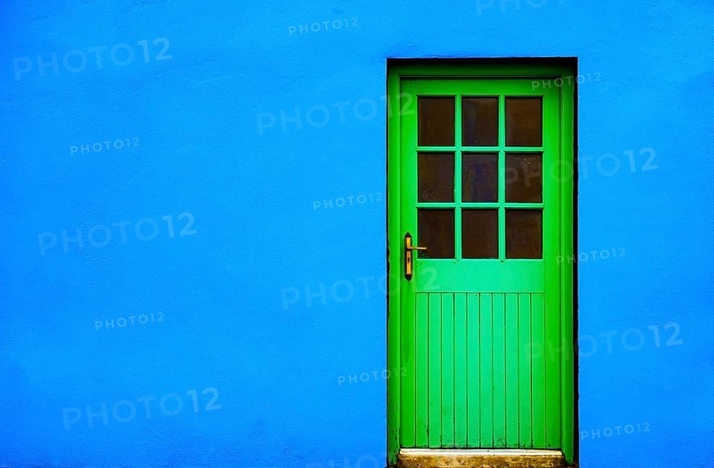 Blue house facade with green front door