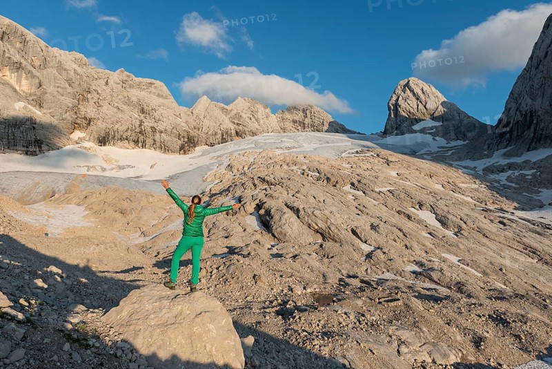 Hiker stretches arms in the air