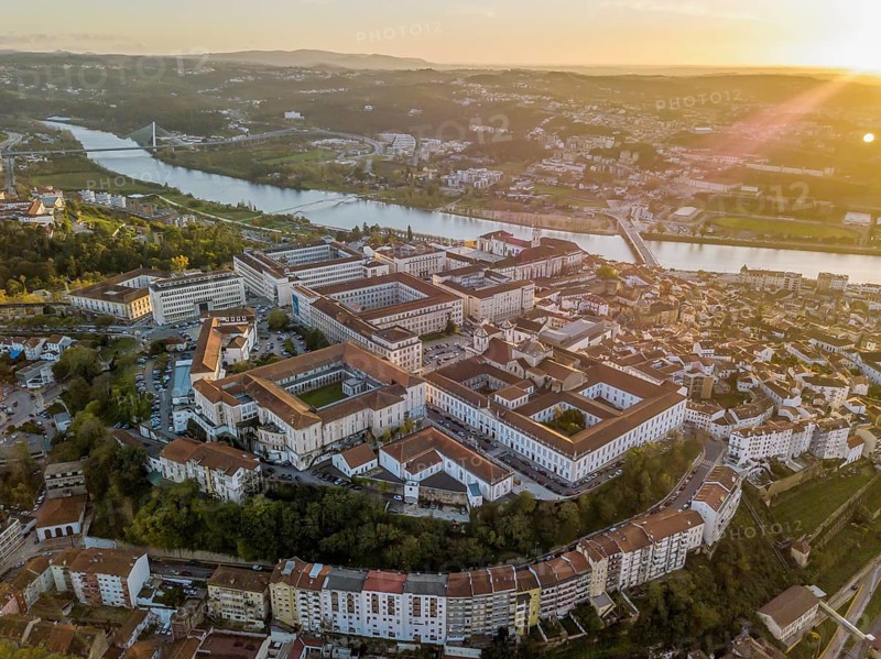 Aerial view of Coimbra with university at top of the hill at sunset