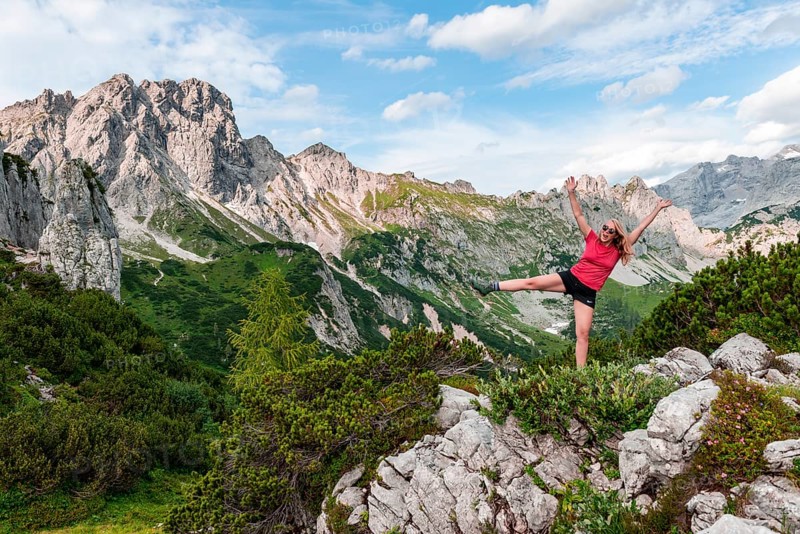 Young woman stretches arms in the air