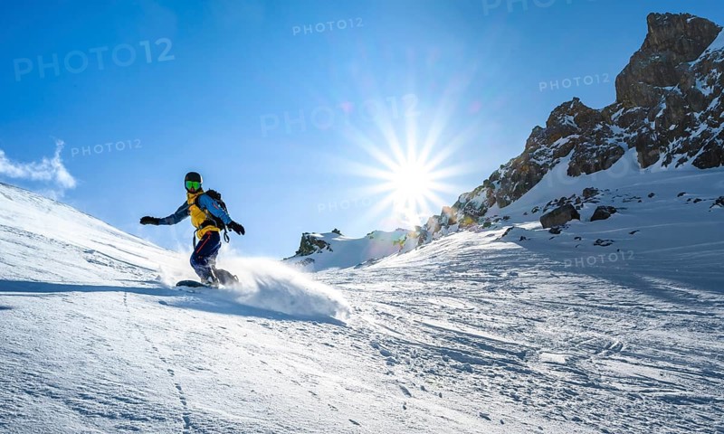 Snowboarder with splitboard rides in the snow