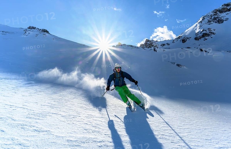 Skier with touring skis skiing in the snow