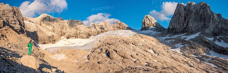 Hiker looks at alpine landscape