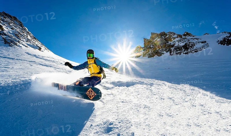 Snowboarder with splitboard rides in the snow