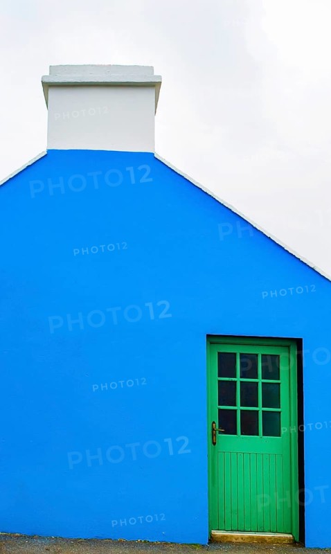 Blue house facade with green front door