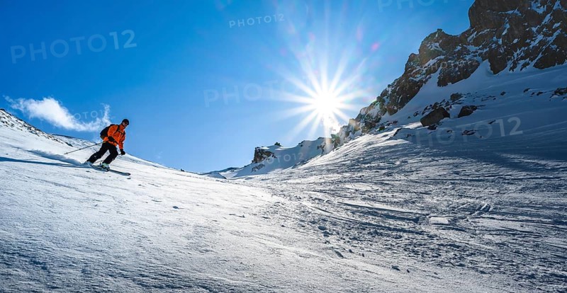 Skier with touring skis skiing in the snow