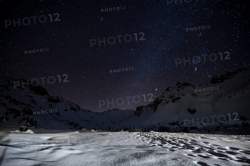 Starry sky with milky way in the mountains in winter