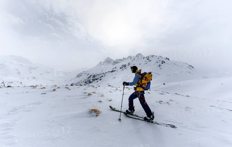 Ski tourers in the snow in fog