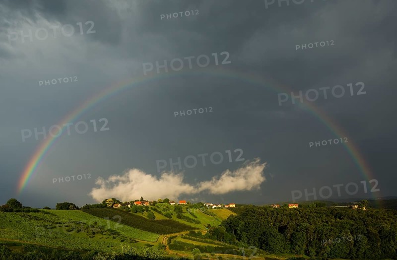 Rainbow with clouds and small village