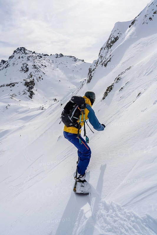 Ski tourers with splitboard on the downhill run