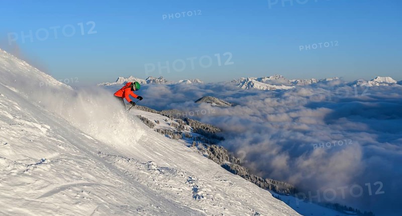 Female skier descending steep slope