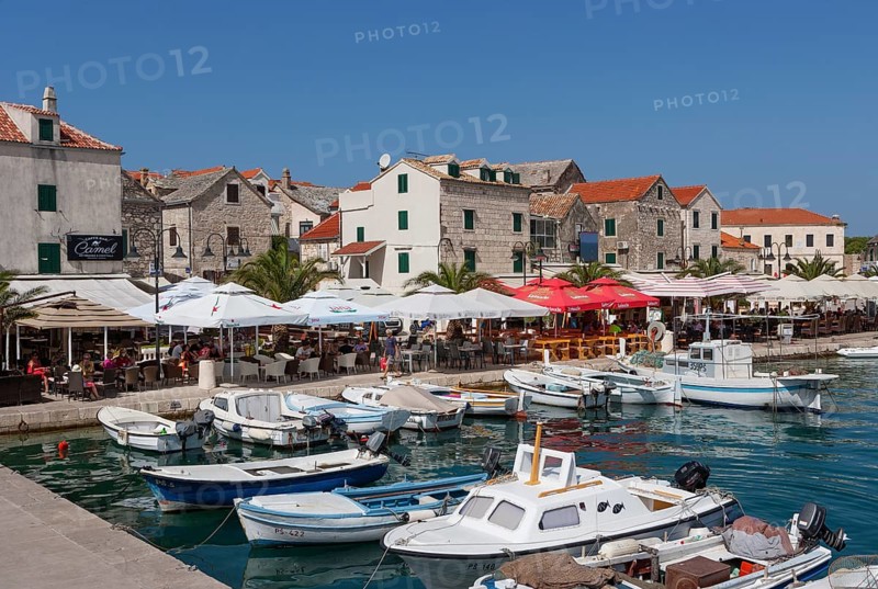 Promenade with fishing boats in the port