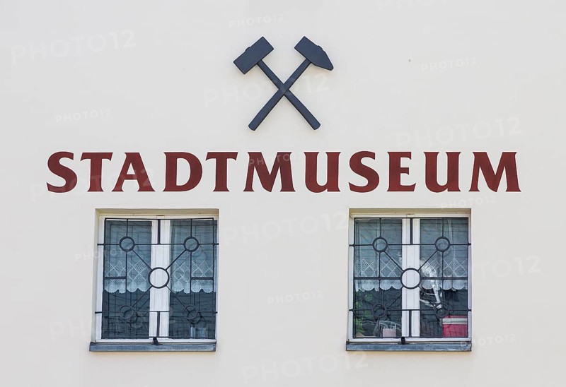 Inscription city museum with symbol mallet and iron