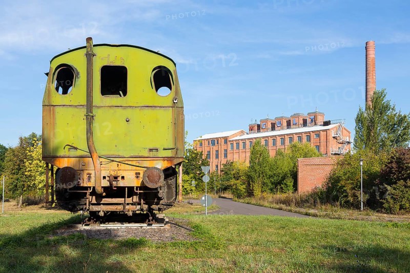 Old locomotive and factory buildings