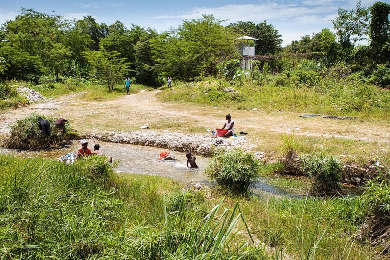 Woman washing clothes on the river