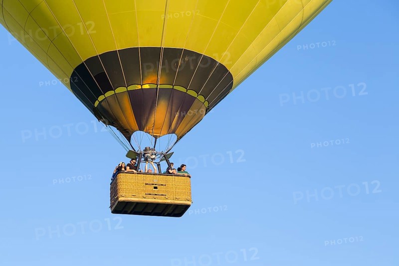 Basket of a hot-air balloon with people