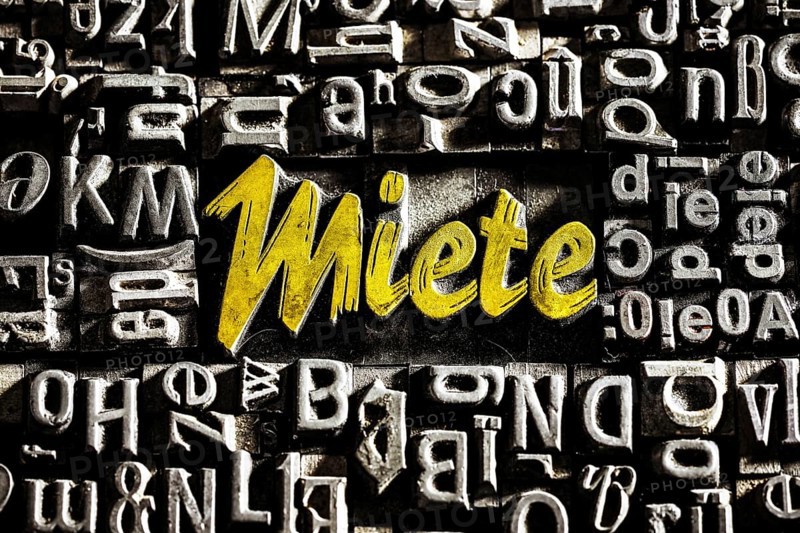 Old lead letters with golden writing show the word rent