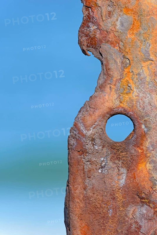 Old rusty sheet pile wall element with hole