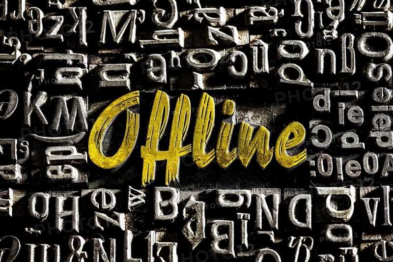 Old lead letters with golden writing show the word offline