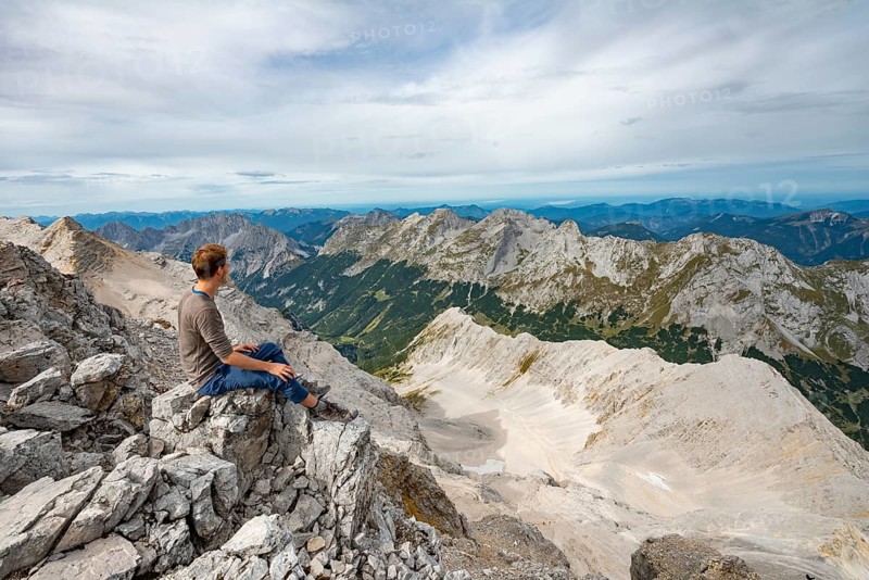 Hiker sitting at the summit of the Birkkarspitze