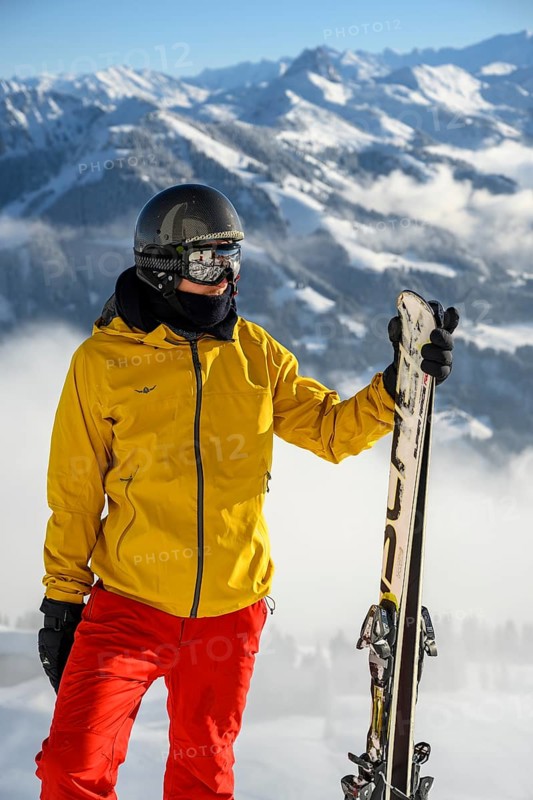 Skier standing at the ski slope holding ski
