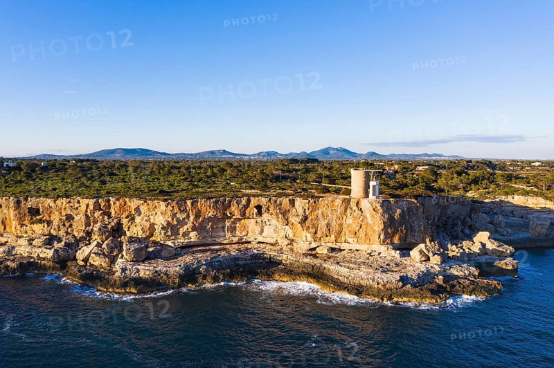 Steep coast with watchtower Torre d'en Beu near Cala Figuera