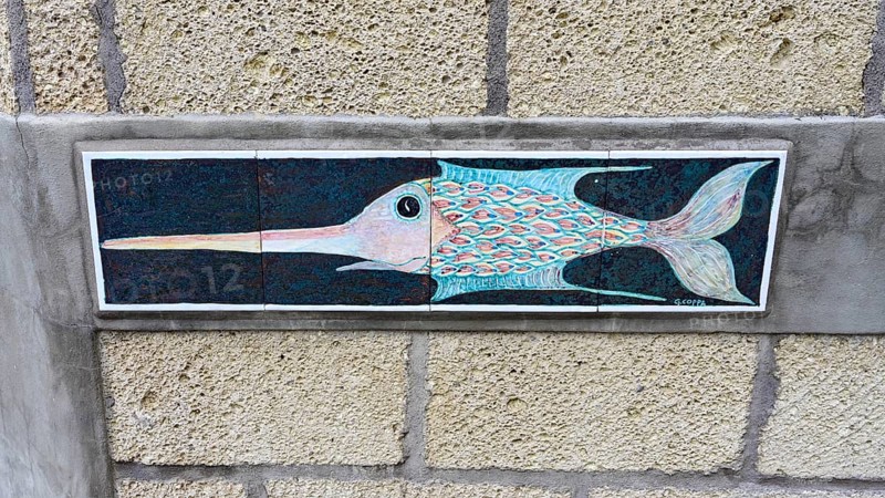 Pottery with fish motif on a house wall
