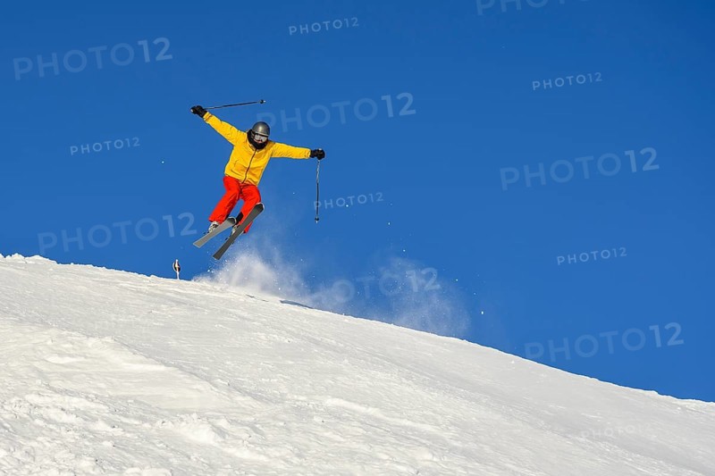 Skiers jumping on the ski slope